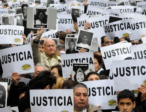 Argentine citizens took to the streets of Buenos Aires on July 18 to demand justice and criticize the agreement their country had reached with Iran, 19 years after the attack against the AMIA Jewish community center, which left 85 dead and hundreds injured. (Hugo Villa Lobos/AFP)