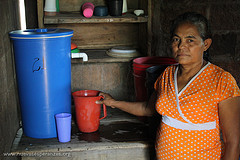 A woman fills a pitcher with water from a "Kanchan" style water filter, which have been distributed by health authorities. (Archive Image)