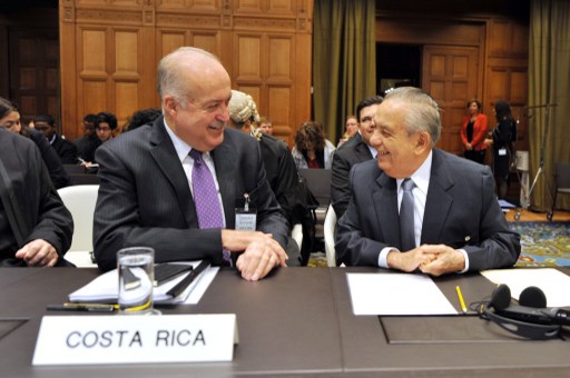 Costa Rica's agent to the court Edgar Ugalde-Alvarez (R) speaks with Costa Rica's ambassador to the Netherlands Jorge Urbina (L) prior to a hearing at the International Court of Justice in The Hague on October 14, 2013. Costa Rica is asking the International Court of Justice to call a halt to the construction by Nicaragua of two canals near the two countries' border. AFP PHOTO/MAUDE BRULARD