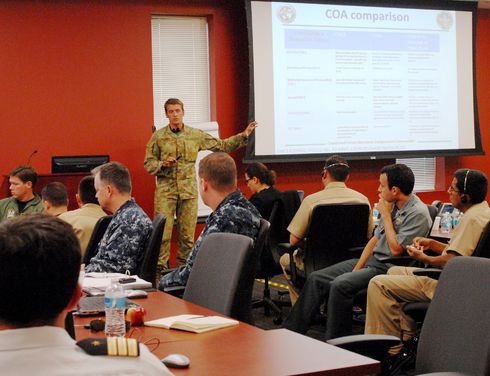Australian Maj. Benjamin Watson, assigned to U.S. Marine Corps 15th Marine Expeditionary Unit, facilitates a war gaming coalition comparison discussion as the Coalition Forces Maritime Component Command cell forms their operational proposal to leadership at Panamax 2013. More than 160 participants from 18 countries gathered together at U.S. Southern Command for the annual exercise that focuses on supporting the Panamanian government in defense of the strategic Panama Canal. (U.S. Navy photo by Chief Mass Communication Specialist Elizabeth Thompson)