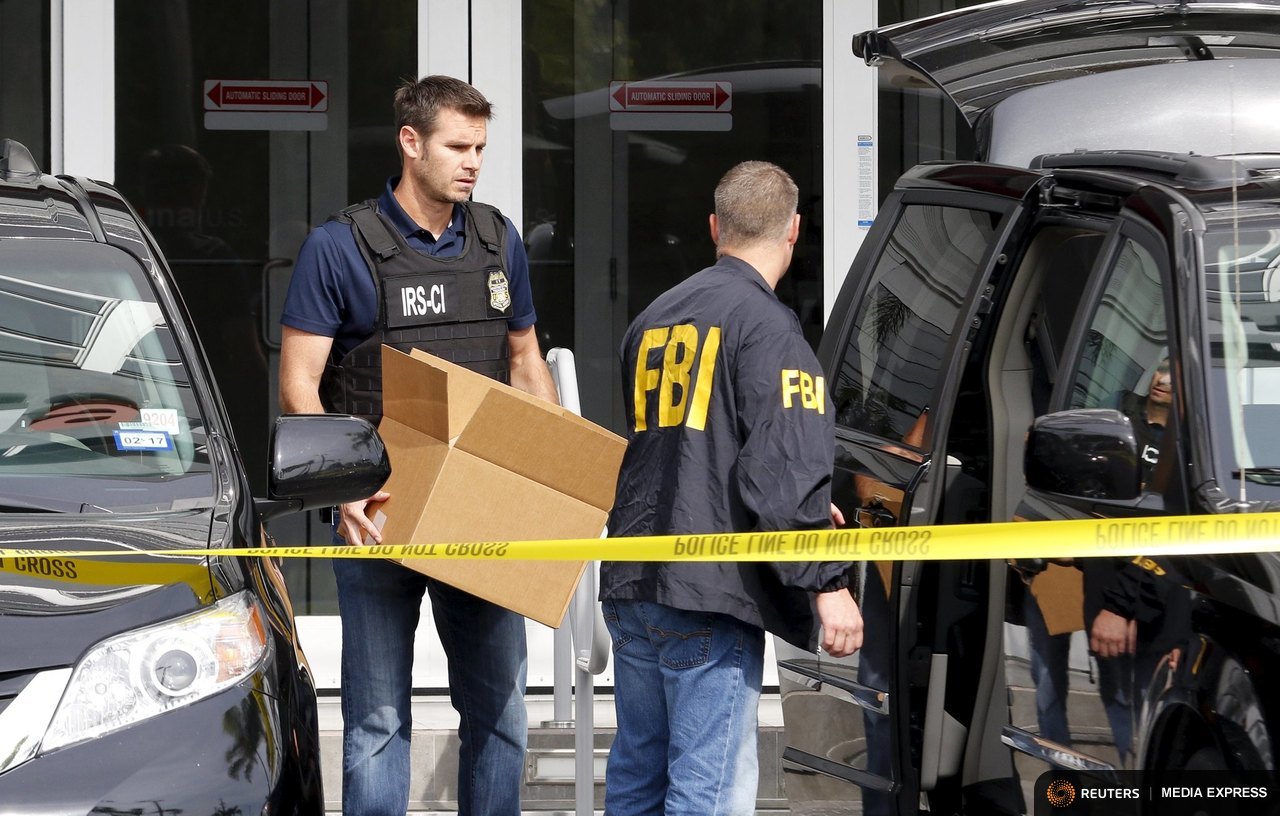 FBI agents remove boxes and other items from the offices of Imagina in Miami, Florida December 3, 2015. REUTERS/Joe Skipper