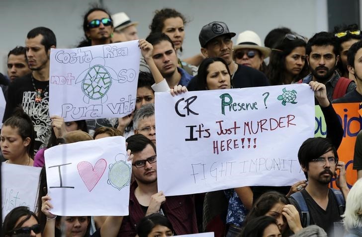 January 29, 2015: Environmentalists protest after a Costa Rican court acquitted seven men accused in the brutal murder of environmentalist Jairo Mora and the rape of four volunteers who worked with him to protect sea turtles, in the coastal city of Limon. REUTERS/Randall Campos  
