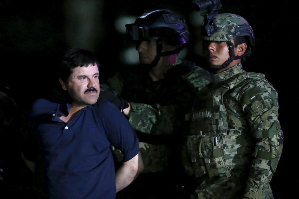 Joaquin "El Chapo" Guzman is escorted by soldiers during a presentation at the hangar belonging to the office of the Attorney General in Mexico City, Mexico January 8, 2016. REUTERS/Edgard Garrido